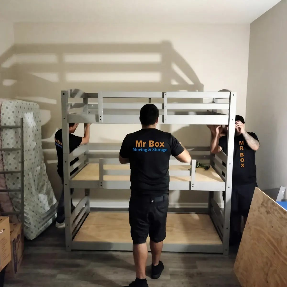 Mr. Box movers assembling a bunk bed