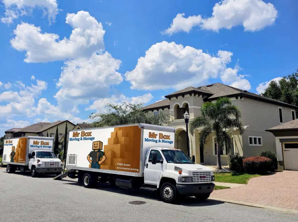 Two trucks displaying Mr. Box branding outside a two-story home